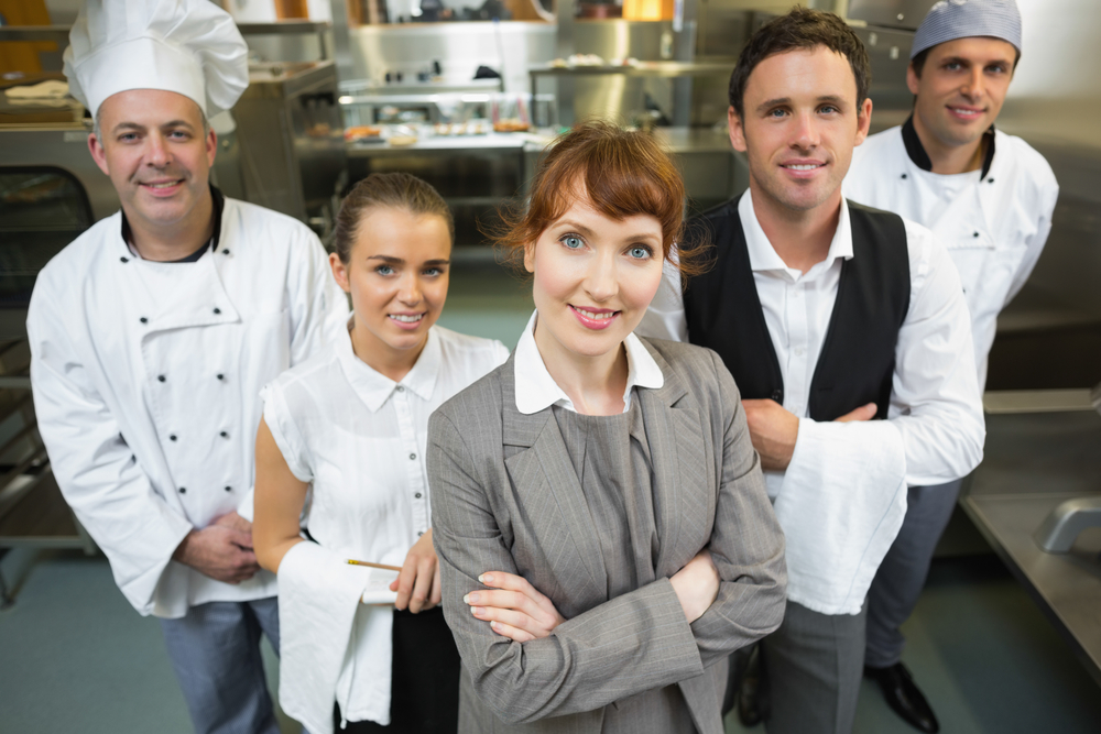 Happy restaurant worker posing for an image