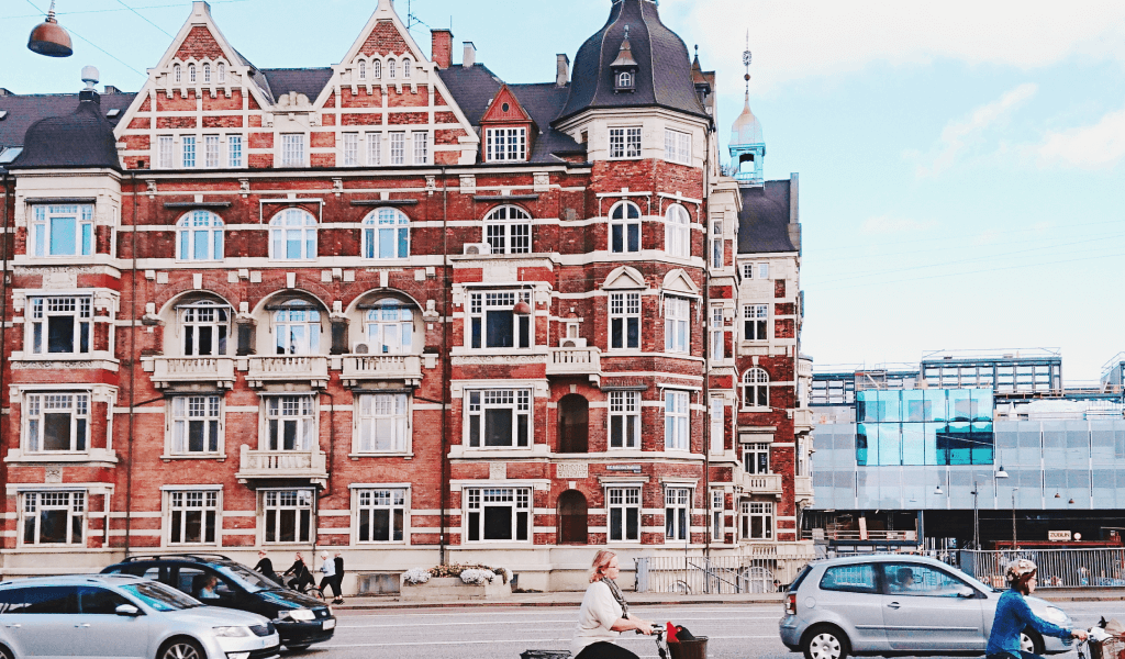 bicycles-road-by-buildings-against-sky