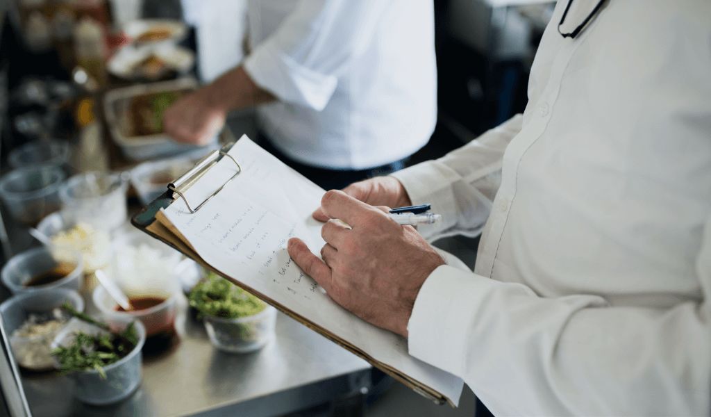 closeup-chef-hand-checking-menu-list
