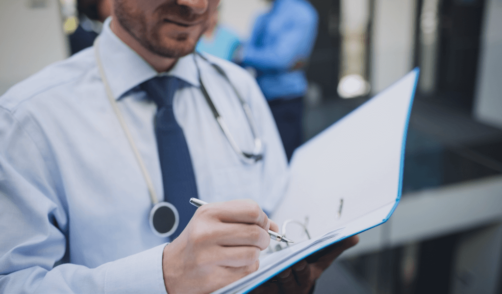 doctor-writing-medical-report