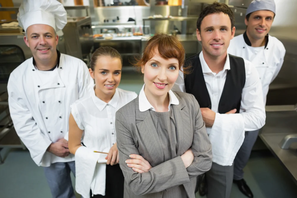 female manager posing with the staff in a modern kitchen-1