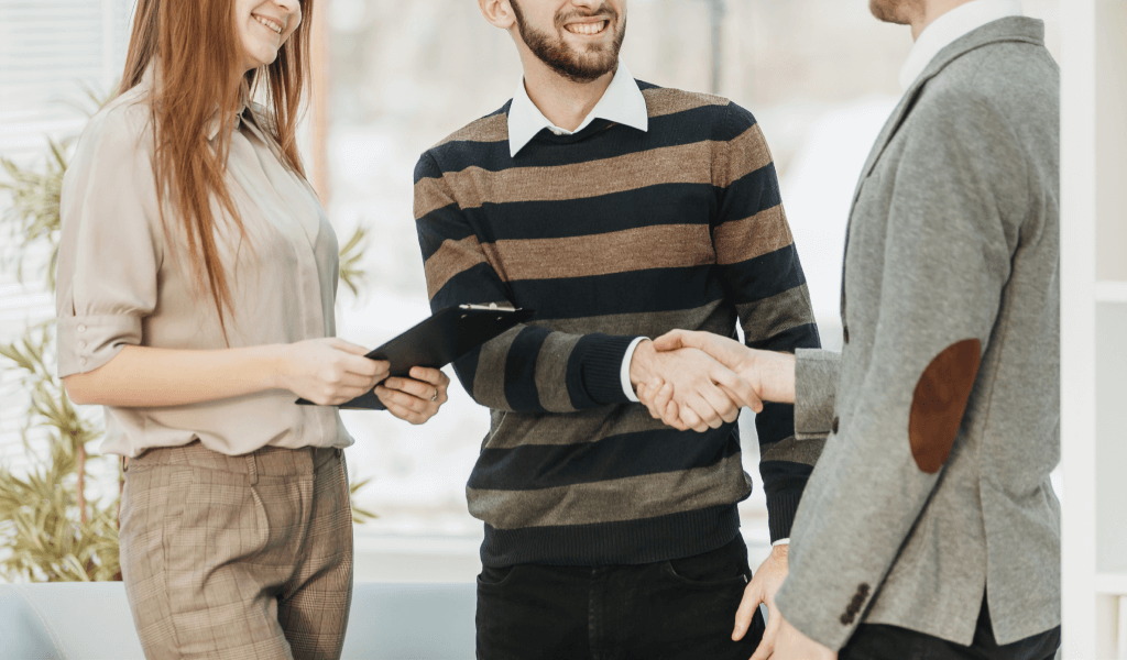 manager-shakes-hands-with-employee-workplace-modern-office manager-shakes-hands-with-employee-workplace-modern-office