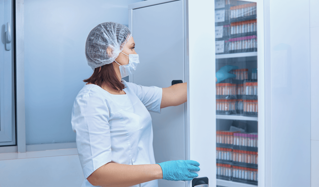 nurse-takes-test-tubes-from-cabinet