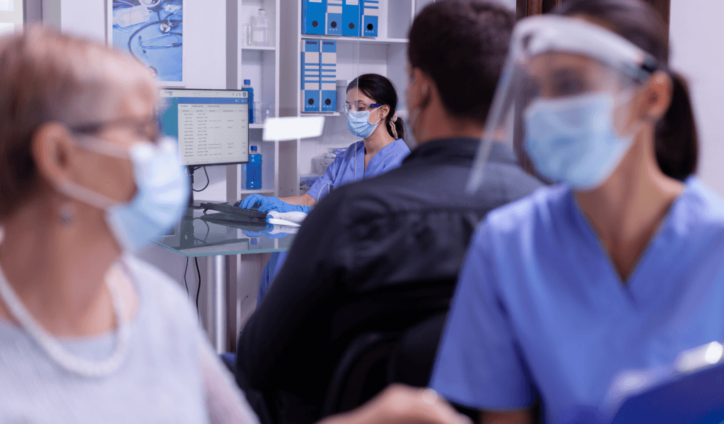 nurse-with-mask-typing-computer-new-patients-appointments